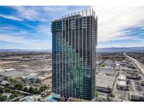Stunning aerial view of a high-rise condo building in the city with gorgeous skyline and mountain views at 4381 W Flamingo Rd # 27308, Las Vegas, NV 89103