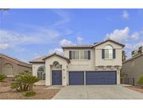 Charming two-story home with a desert landscape, two car garage, and decorative blue trim at 6407 Wild Strawberry Ln, Las Vegas, NV 89142