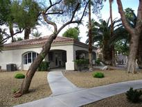 Charming single-story home with a stucco exterior and desert landscaping providing inviting curb appeal at 6480 Annie Oakley Dr # 111, Las Vegas, NV 89120