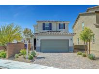 Charming two-story home featuring a paved driveway and a two-car garage at 8349 Pollenzo Ave, Las Vegas, NV 89178