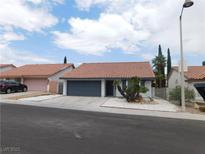Charming single-story home featuring a tile roof, two-car garage, and low-maintenance desert landscaping at 8640 Portofino Ct, Las Vegas, NV 89117