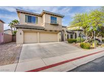 Charming two-story home with a two-car garage, lush landscaping, and a well-maintained driveway at 9052 Pine Mission Ave, Las Vegas, NV 89143