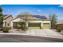 Charming single-story home featuring a two-car garage, desert landscaping, and solar panels for energy efficiency at 916 Bob Barney Ct, North Las Vegas, NV 89086