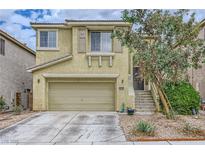 Charming two-story home with a two-car garage and well-maintained landscaping, offering curb appeal at 10798 Muscari Way, Las Vegas, NV 89141