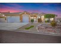 Charming single-story home with a three-car garage, desert landscaping, and unique architectural details at 1124 Whistle Ct, Henderson, NV 89011