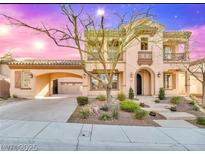 Elegant two-story home with stucco exterior, arched entryway, balcony, desert landscaping, and covered porte-cochere at 2805 Proust Ct, Henderson, NV 89044