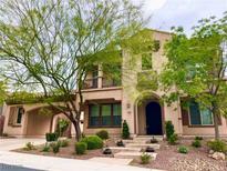 Charming two-story home with landscaped front yard, featuring a portico, balconies, and mature desert landscaping at 2805 Proust Ct, Henderson, NV 89044