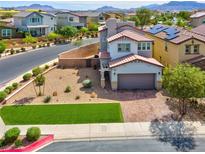 Charming two-story home with brick driveway, desert landscaping, and mountain views at 301 Resolute Ave, Henderson, NV 89011
