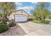 Charming single story home with a two-car garage, red tile roof, and desert landscaping at 3029 Paseo Hills Way, Henderson, NV 89052