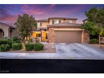 Beautiful two-story home with stone accents, a two-car garage, and well-manicured landscaping, showcasing its curb appeal at 5144 Poem Ct, North Las Vegas, NV 89081