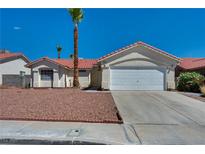 Inviting single-story home with a well-manicured yard and a two-car garage at 520 Stonehurst Dr, North Las Vegas, NV 89031
