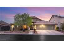 Charming single-story home with a manicured front yard and a spacious three-car garage at 5940 Vizzi Ct, Las Vegas, NV 89131