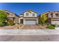 Charming two-story home featuring a neatly maintained front yard, stone pathway, and two-car garage at 9010 Eagle Wall Ct, Las Vegas, NV 89178