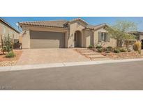 Charming single-story home with a tiled roof, neat landscaping, and a two-car garage at 10126 Cliff Dwellings Ave, Las Vegas, NV 89178