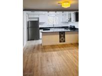 Bright kitchen features updated appliances, breakfast bar, and ample countertop space at 3275 Arville St # C, Las Vegas, NV 89102