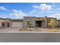 Beautiful single story home with desert landscaping, stone accents, and an attached three car garage at 10018 Regency Square Ave, Las Vegas, NV 89148