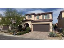 Charming two-story home with a well-manicured lawn, a basketball hoop, and a two-car garage at 10976 Bluebell Basin Rd, Las Vegas, NV 89179