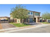 Charming two-story home featuring a well-manicured lawn and a spacious driveway at 1512 Sagefield Way, Logandale, NV 89021