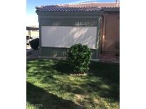 Cozy backyard featuring a green wooden fence and a small trimmed bush at 461 N Lamb Blvd # H, Las Vegas, NV 89110