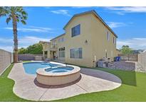 Backyard with pool, spa, palm tree, and artificial grass at 8828 Monte Oro Dr, Las Vegas, NV 89131