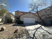 Charming two-story home with a two-car garage and a low-maintenance desert landscape at 3728 Ashling St, Las Vegas, NV 89129