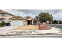 Charming single-story home featuring a two-car garage and low-maintenance desert landscaping at 4484 Warbonnet Way, Las Vegas, NV 89147
