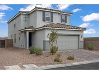 Charming two-story home with a neutral color scheme, attached garage, and low maintenance landscaping at 5692 Tinar St, Las Vegas, NV 89113