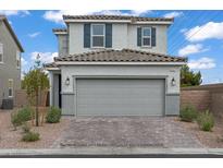 Inviting two-story home features a gray exterior, tiled roof, and two-car garage at 5692 Tinar St, Las Vegas, NV 89113