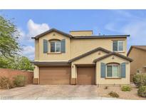Charming two-story home featuring a three-car garage, neat landscaping, and decorative shutters at 10412 Deer Heights St, Las Vegas, NV 89178