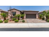 Charming single-story home featuring a two-car garage and desert landscaping at 1128 Via Della Curia, Henderson, NV 89011