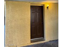 A close up of the front door with 'B' on it, with a light shining above the door at 1447 Hialeah Dr # B, Las Vegas, NV 89119