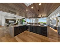 Open concept kitchen with a large island, modern appliances, and wood flooring at 2548 Faiss Dr, Las Vegas, NV 89134