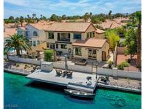 Stunning waterfront home with a private dock, boat, and outdoor seating area for enjoying the lake views at 2708 Port Of Call Dr, Las Vegas, NV 89128