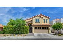 Charming two-story home with a landscaped front yard and a two-car garage at 2708 Port Of Call Dr, Las Vegas, NV 89128