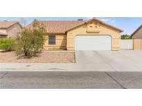 Single-story home featuring a two-car garage and low-maintenance landscaping at 5224 Dana Springs Way, Las Vegas, NV 89130