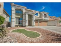 Charming two-story home featuring a spacious three-car garage and a professionally landscaped front yard at 664 Mystic Cliffs Ave, Las Vegas, NV 89183