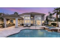 Stunning backyard oasis with a pool, spa, and outdoor kitchen perfect for entertaining guests at 8801 Rozetta Ct, Las Vegas, NV 89134