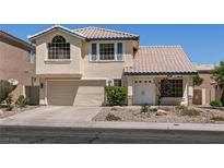 Charming two-story home featuring a tile roof, attached two-car garage, and well-maintained front yard at 9044 Crimson Clover Way, Las Vegas, NV 89134