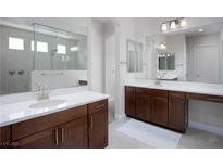 Modern bathroom featuring dual vanities, a large mirror, and a spacious walk-in shower at 1130 Calico Rdg, Mesquite, NV 89034