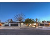 Charming single-story home featuring a well-maintained front yard and a large, attached two-car garage at 4667 E Boston Ave, Las Vegas, NV 89104