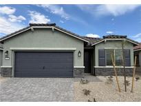 Charming single-story home featuring a two-car garage and desert landscaping at 3236 Walker River St, North Las Vegas, NV 89032