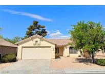 Single-story home with a two-car garage and well-maintained landscaping at 3523 Calf Roper Ct, North Las Vegas, NV 89032