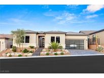Modern single-story home with well-manicured landscaping, three car garage, and inviting entrance at 36 Thorn Creek St, Henderson, NV 89011