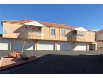 Inviting multi-Gathering home featuring a well-maintained stucco exterior and ample garage parking spaces at 8452 Boseck Dr # 225, Las Vegas, NV 89145
