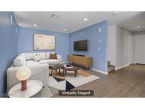 Bright living room with modern decor and a comfortable white sectional sofa at 9932 Keephills St, Las Vegas, NV 89183