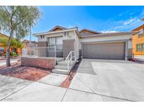 Charming single-story home with desert landscaping, covered porch, and attached two-car garage at 173 Calm Morning Ave, Henderson, NV 89002