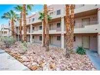 Condominium exterior featuring desert landscaping, a walkway and access to the building's entrances at 2044 Mesquite Ln # 202, Laughlin, NV 89029