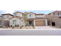 Beautiful two-story home featuring a two-car garage, desert landscaping, and a welcoming front entrance at 230 Carmel Sky St, Las Vegas, NV 89138