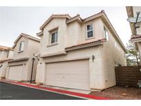 Charming two-story townhome featuring a red tile roof and a spacious two-car garage at 3018 Sunrise Bay Ave, North Las Vegas, NV 89031