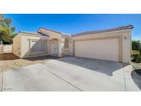 Charming single-story home with a two-car garage and low maintenance desert landscaping at 4716 Cohiba Way, North Las Vegas, NV 89031